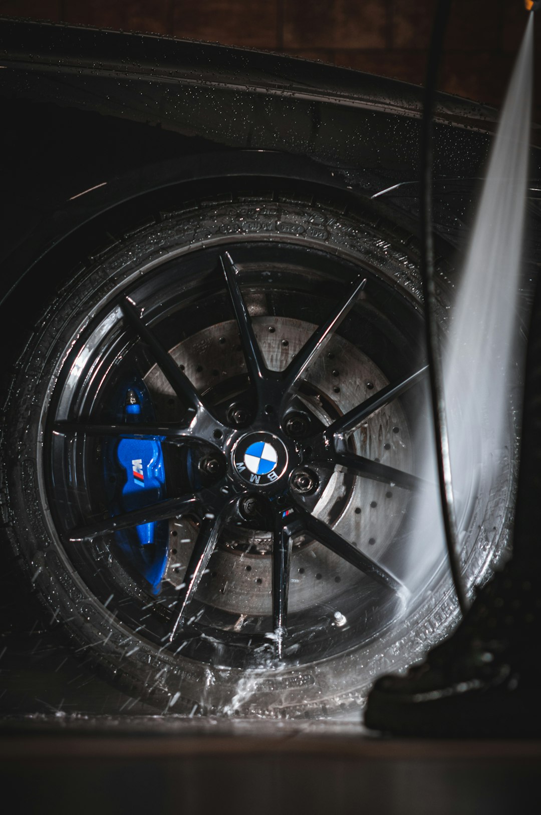 a-close-up-of-a-car-tire-with-a-spray-of-water-on-it-mkob5r85ms0